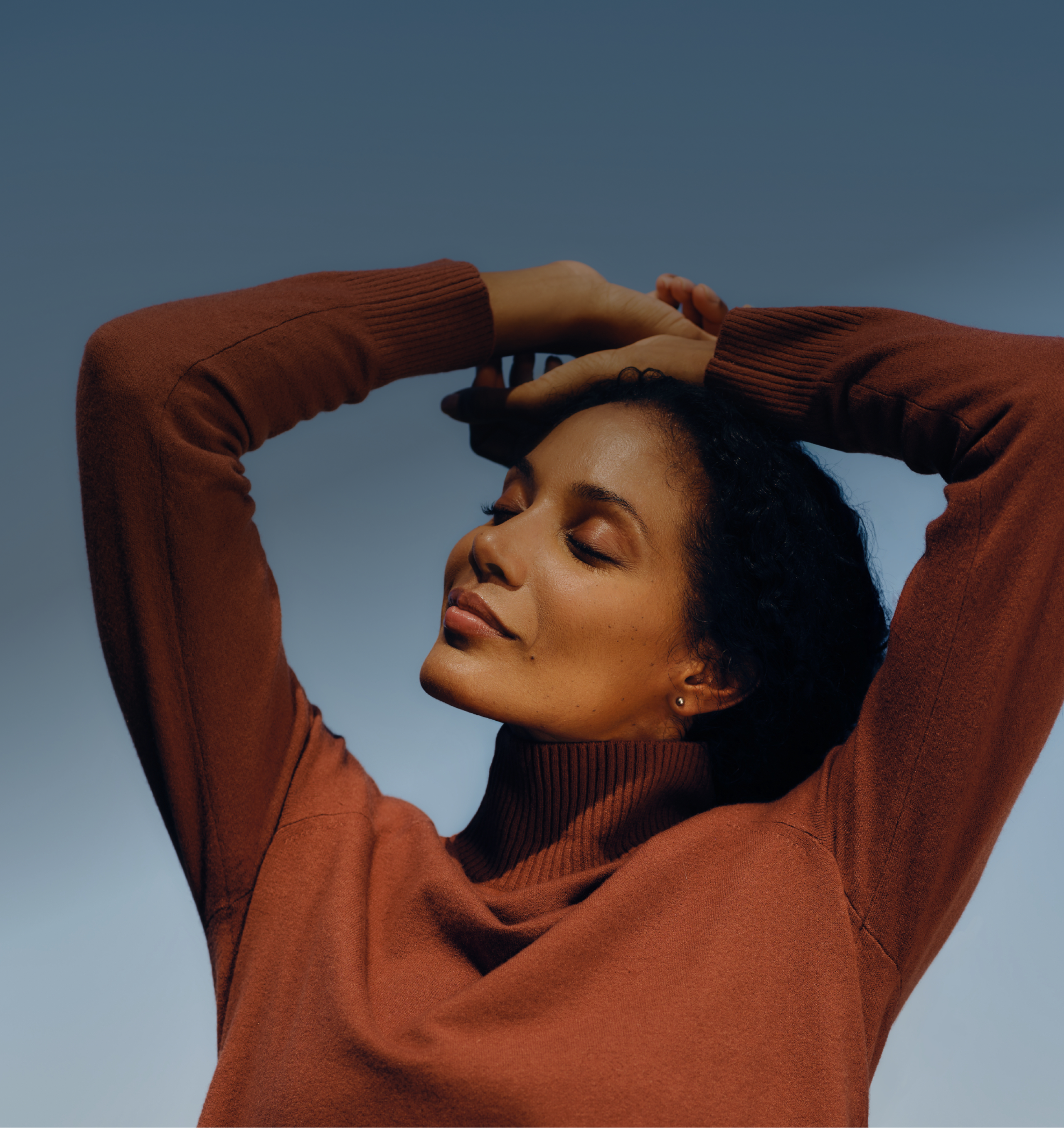 A woman with her arms stretched above her head