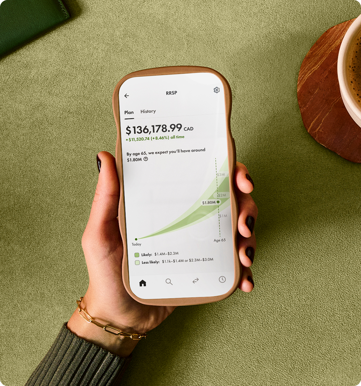 A photo of a hand holding a mobile phone with the Wealthsimple app open to a RRSP account.