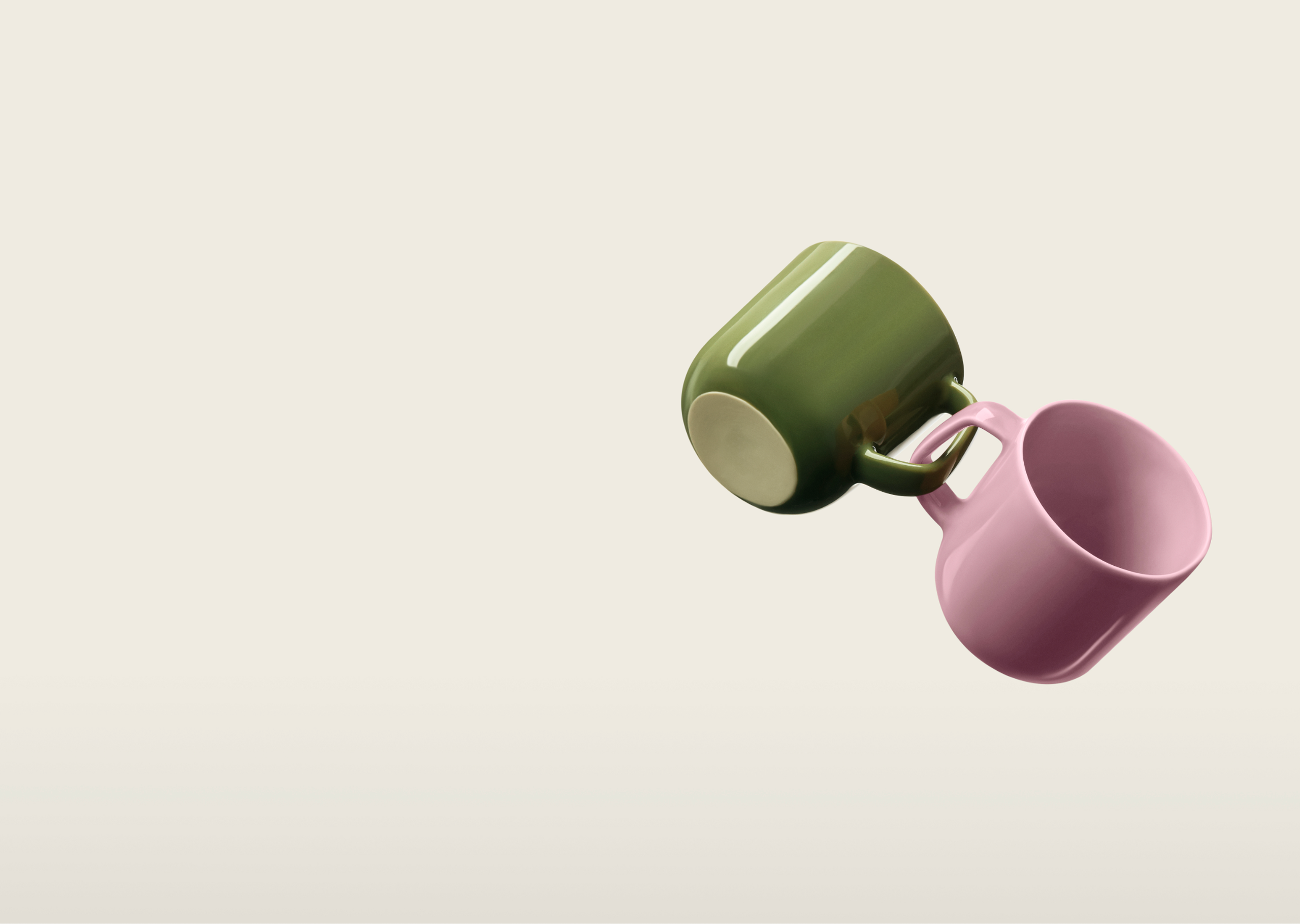 A green and pink mug, linked by their handles.
